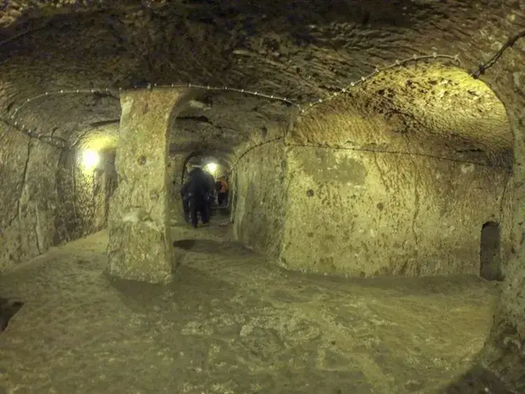 Explore the mysteries of Derinkuyu, the largest underground city housing 20,000 people. Delve into its rich history and ingenious design. Unearth a hidden world beneath Cappadocia's enchanting landscape.