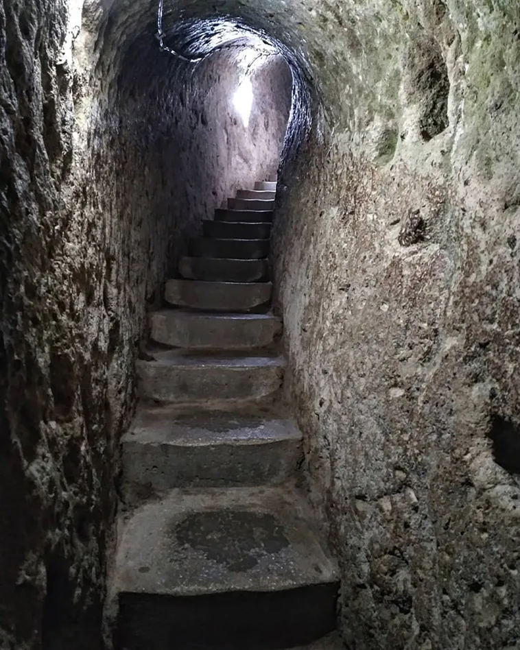 Explore the mysteries of Derinkuyu, the largest underground city housing 20,000 people. Delve into its rich history and ingenious design. Unearth a hidden world beneath Cappadocia's enchanting landscape.