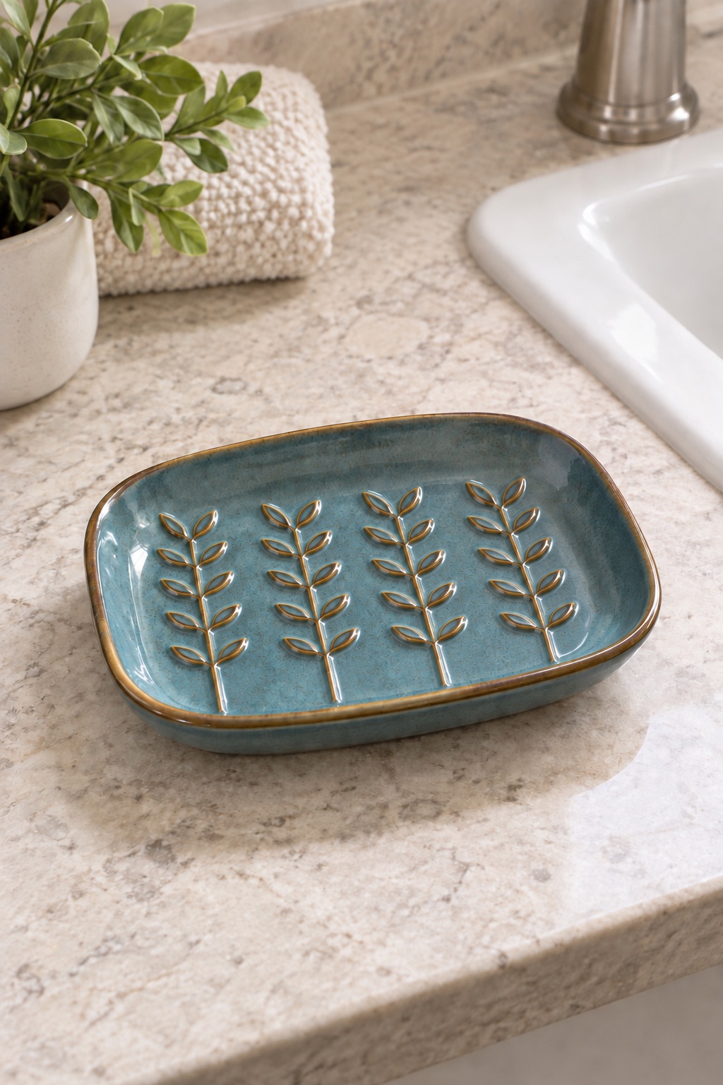 AI-generated visualization approximating the design of the HighHerz Raised-Relief Ceramic Soap Dish, Blue beside a guest-bathroom sink.